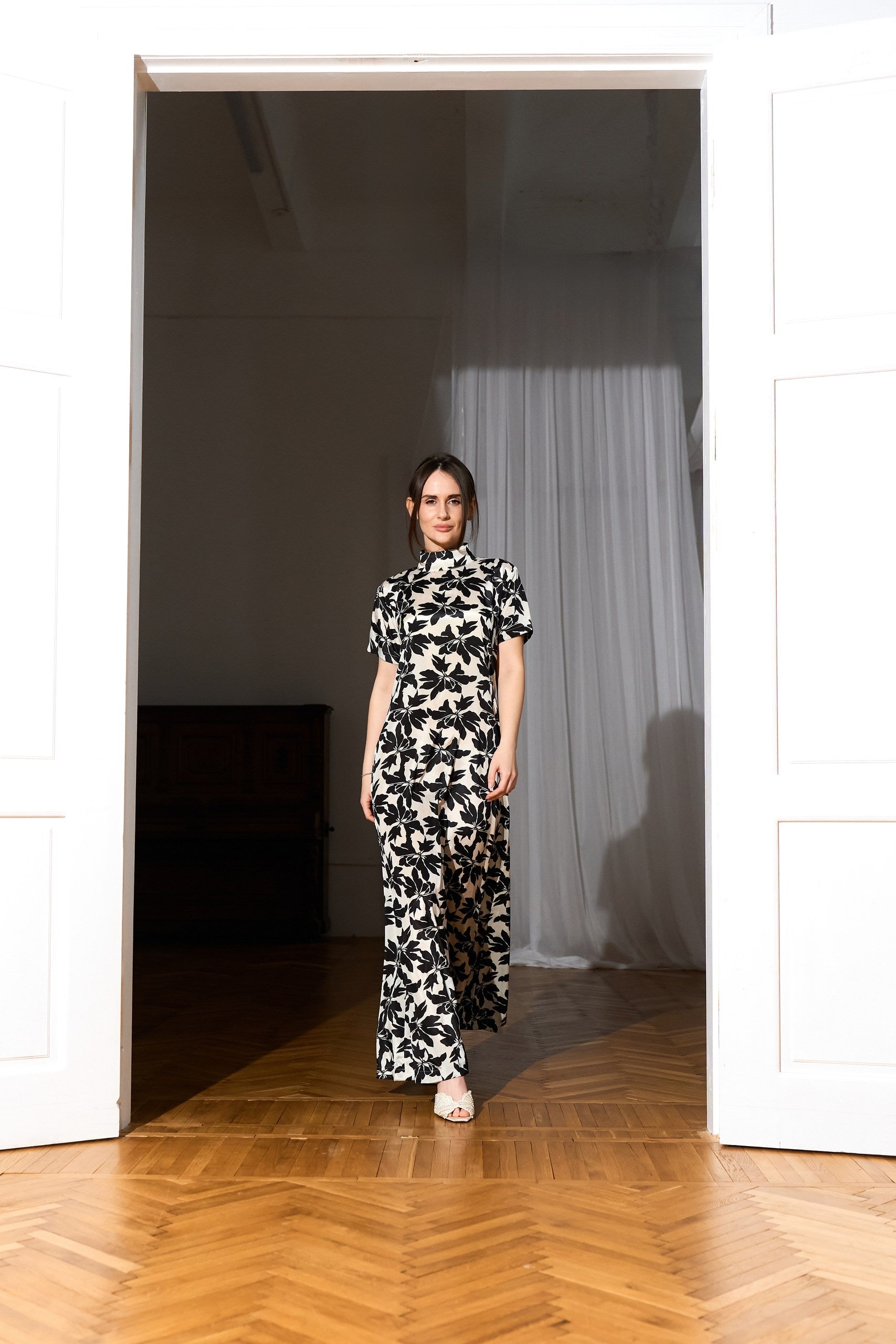 A silk Black & White floral maxi dress from front lifestyle image