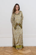 Long sleeved silk dress with a an olive floral pattern from the front 