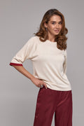 Ivory relaxed knit top with contrast stripe sleeve detail and soft drape